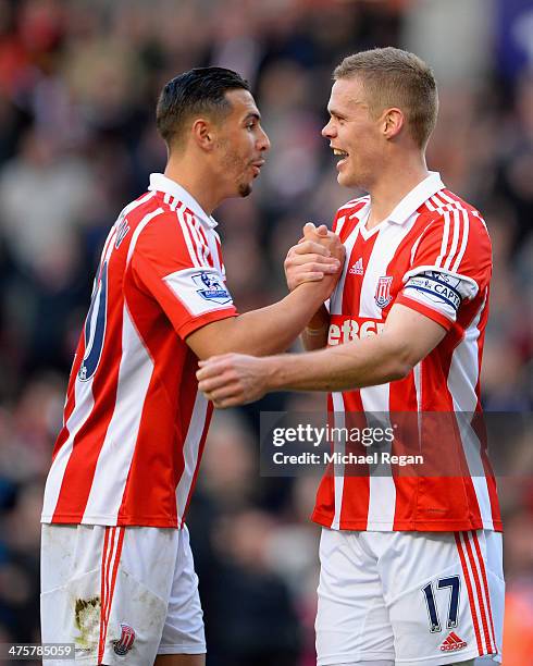 Geoff Cameron of Stoke City celebrates with team-mate Ryan Shawcross at the end of the Barclays Pemier League match between Stoke City and Arsenal at...