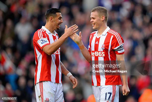 Geoff Cameron of Stoke City celebrates with team-mate Ryan Shawcross at the end of the Barclays Pemier League match between Stoke City and Arsenal at...