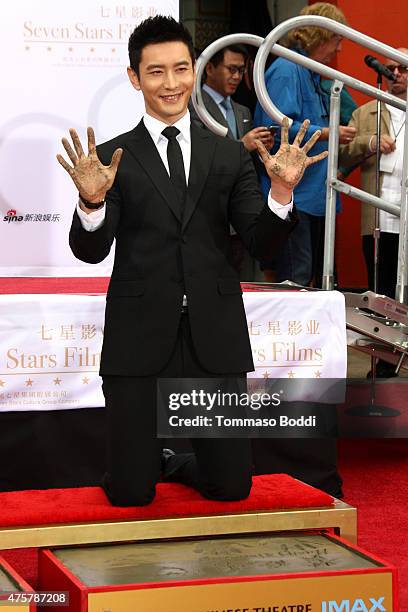 Actor Huang Xiaoming is honored with hand/footprint ceremony during the 88th Birthday Commemoration Of TCL Chinese Theatre IMAX at the TCL Chinese...