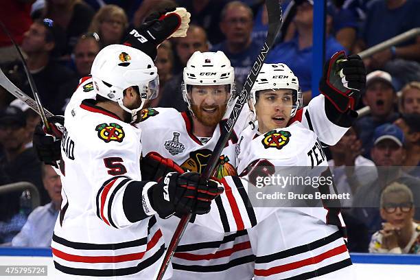 Teuvo Teravainen celebrates his third period goal with Duncan Keith and David Rundblad of the Chicago Blackhawks against the Tampa Bay Lightning...