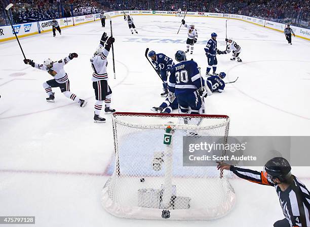 Patrick Sharp of the Chicago Blackhawks celebrates a goal by teammate Antoine Vermette against goalie Ben Bishop and the Tampa Bay Lightning during...