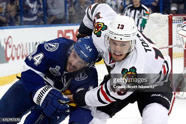 Jonathan Toews of the Chicago Blackhawks and Ryan Callahan of the Tampa Bay Lightning battle for the puck during Game One of the 2015 NHL Stanley Cup...