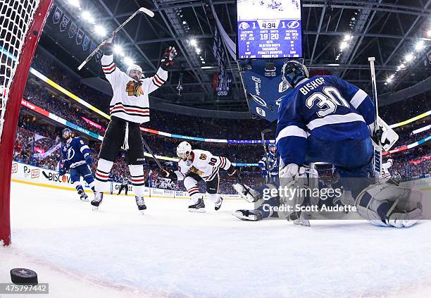 Patrick Sharp of the Chicago Blackhawks celebrates a goal by teammate Antoine Vermette against goalie Ben Bishop and the Tampa Bay Lightning during...