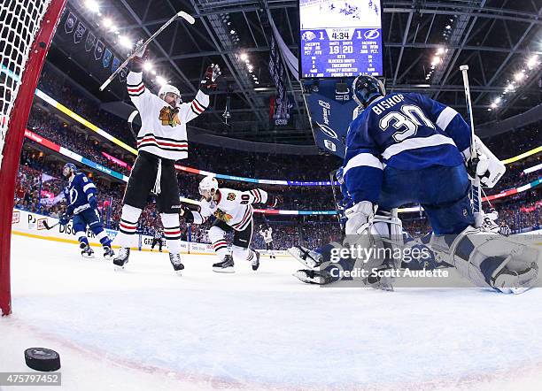 Patrick Sharp of the Chicago Blackhawks celebrates a goal by teammate Antoine Vermette against goalie Ben Bishop and the Tampa Bay Lightning during...