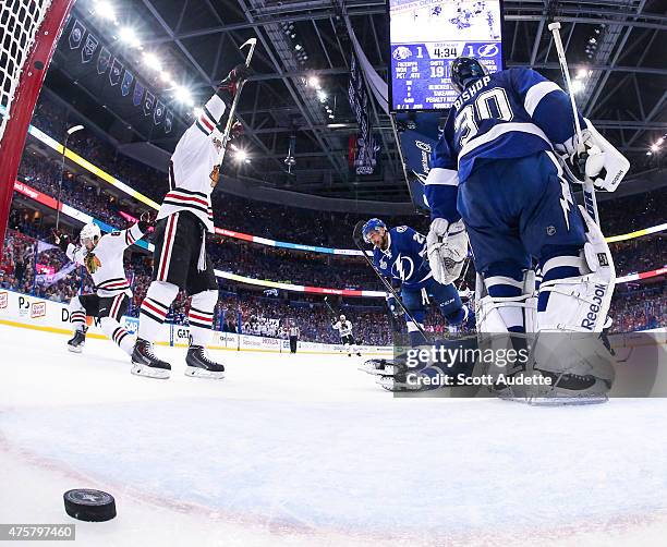 Patrick Sharp of the Chicago Blackhawks celebrates a goal by teammate Antoine Vermette against goalie Ben Bishop and the Tampa Bay Lightning during...