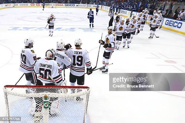 Jonathan Toews of the Chicago Blackhawks celebrates with teammates after defeating the Tampa Bay Lightning 2-1 in Game One of the 2015 NHL Stanley...