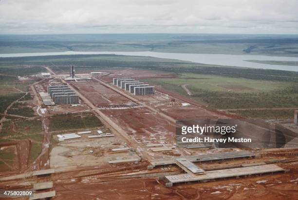 The construction of the Esplanada dos Ministerios on the Monumental Axis in Brasilia, Brazil, with the Cathedral of Brasilia on the right, and the...