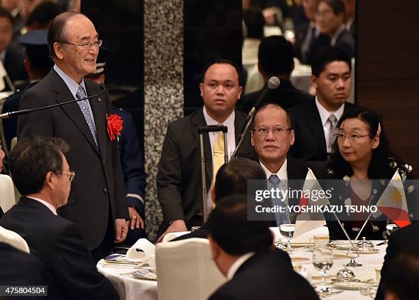 Akio Mimura , president of the Japan Chamber of Commerce, delivers a speech as visiting Philippine President Benigno Aquino listens, as they attend a...