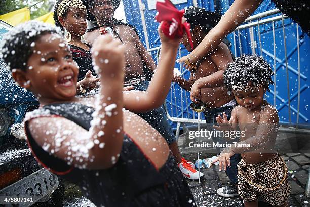 The Pereira family revels in fake snow while dancing during the 'Ceu na Terra' street carnival bloco on March 1, 2014 in Rio de Janeiro, Brazil....