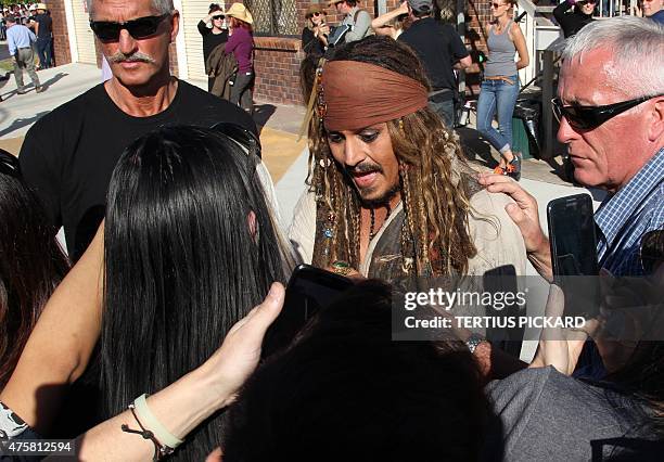 Hollywood actor Johnny Depp , dressed as Captain Jack Sparrow from the Pirates of the Caribbean film franchise, greets fans after returning from a...