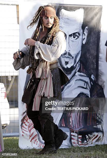 Hollywood actor Johnny Depp, dressed as Captain Jack Sparrow from the Pirates of the Caribbean film franchise, returns from a day on the film set, in...
