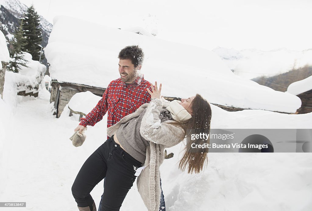 Young couple playing with snow