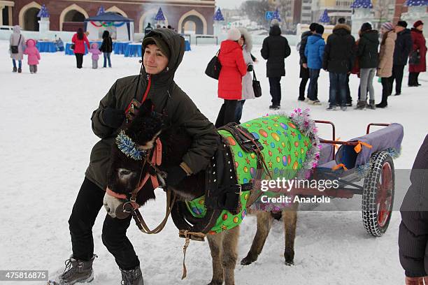 Hundreds of people attend the celebrations of the "Maslennitsa" holiday on March 1, 2014 at the capital Kazan of Tatarstan province of Russia. A boy...
