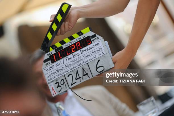 An assistant gets ready withe clapper-board on the set at Piazza della Pace in central Rome during the filming of US film director Woody Allen's new...