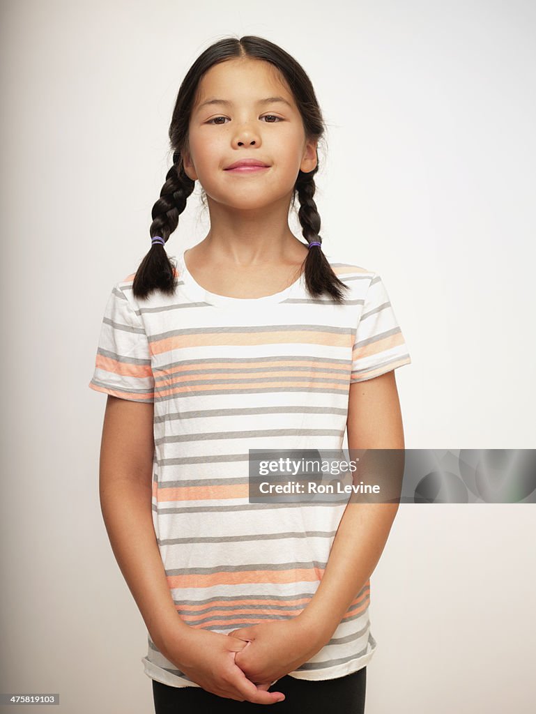 Young girl in striped shirt and braids, portrait