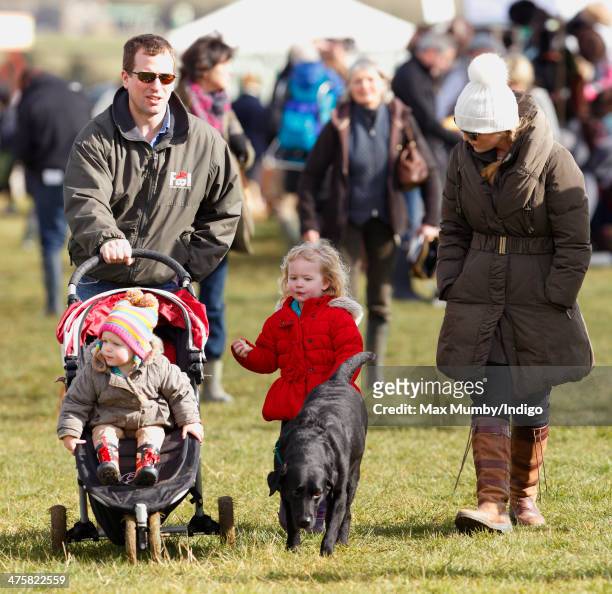 Peter Phillips pushes daughter Isla Phillips in her pushchair, whilst eldest daughter Savannah Phillips walks the family dog along with Autumn...