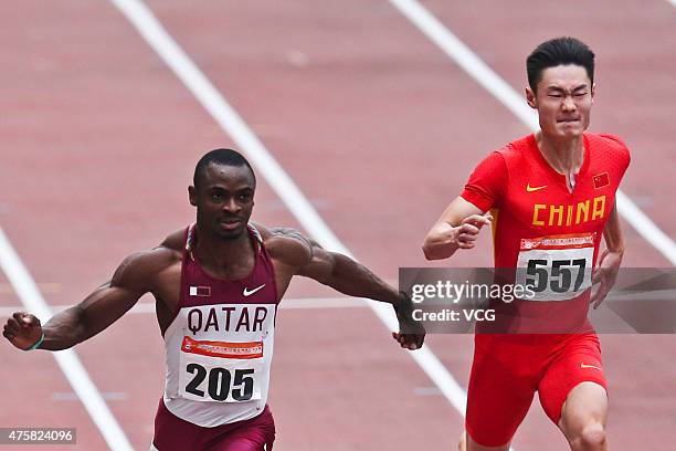 Femi Seun Ogunode of Qatar and Zhang Peimeng of China compete in the Men's 100m Final during day two of the 21st Asian Athletics Championships at...