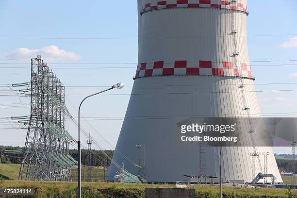 Electricity pylons stand beside a cooling tower at the Novovoronezh NPP-2 nuclear power station, operated by OAO Rosenergoatom, a unit of Rosatom...