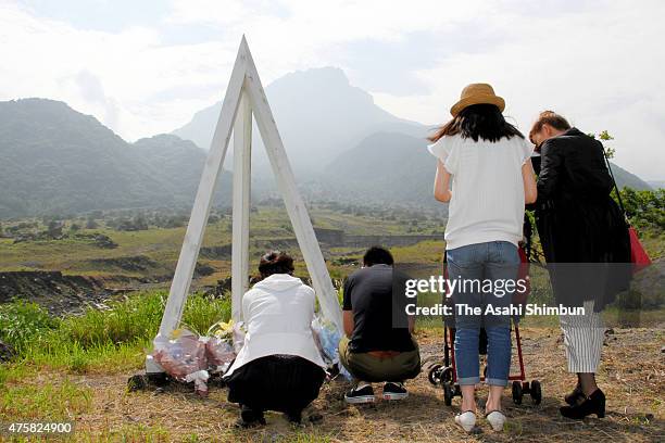 Family members of the victims of the pyroclastic flow of Mount Unzen pray on June 3, 2015 in Shimabara, Nagasaki, Japan. 43 firefighters and...