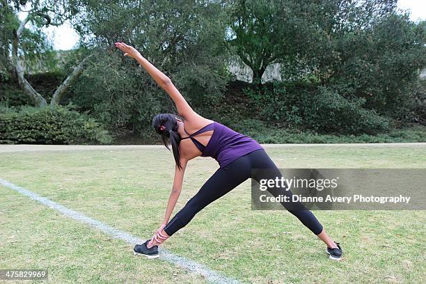 teen stretching in park - girls in leggings stock-fotos und bilder