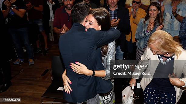 Xavi Hernandez embraces his wife during the 'FC Barcelona Homage to Xavi' ahead of his final game for the club at Camp Nou on June 3, 2015 in...