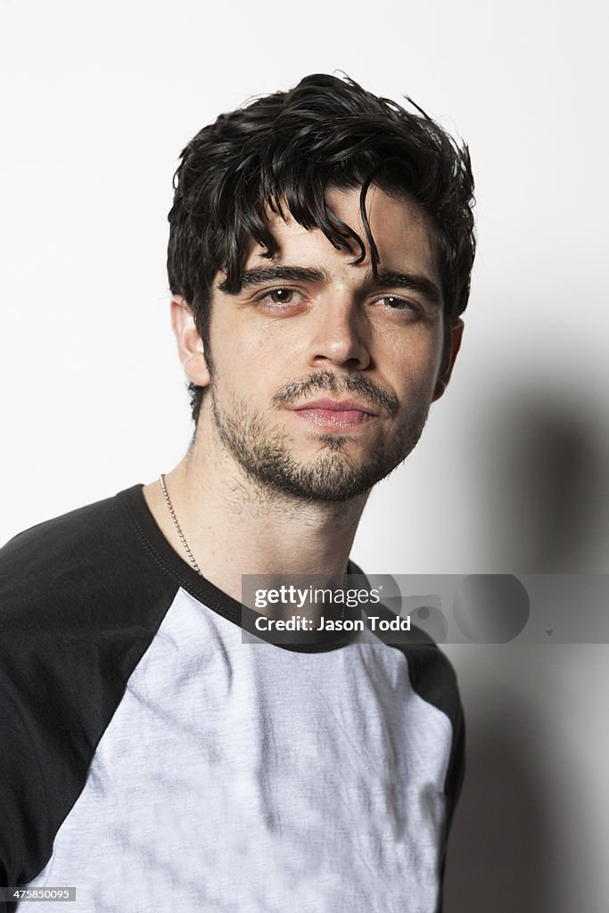 Young man on white with shaggy black hair