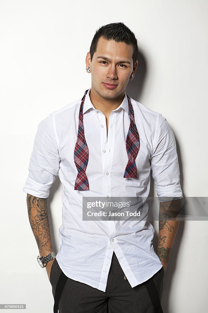 Young man on white with tattoos in dress attire