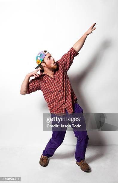 man doing greek god pose in colorful clothes - human arm stock-fotos und bilder