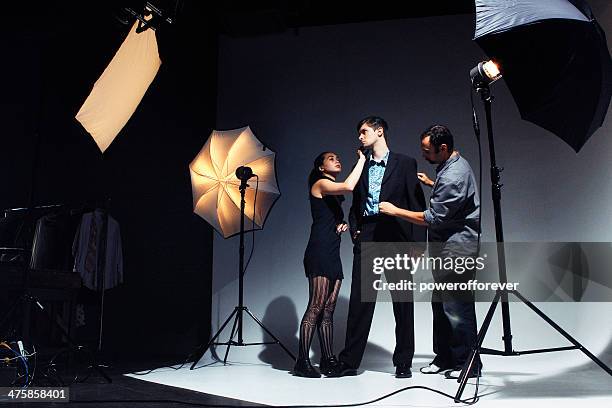 makeup artist and stylist working on model - behind-the-scenes stock pictures, royalty-free photos & images