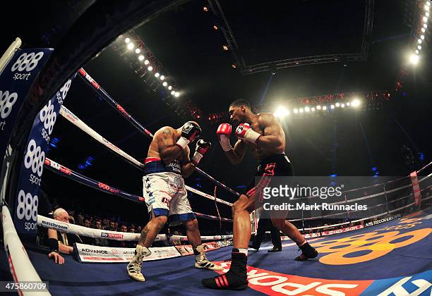 Anthony Joshua clashes with Hector Avila during an undercard bout at the WBO World Lightweight Championship Boxing match at the Glasgow SECC on March...
