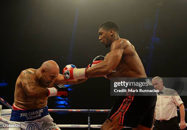 Anthony Joshua clashes with Hector Avila during an undercard bout at the WBO World Lightweight Championship Boxing match at the Glasgow SECC on March...