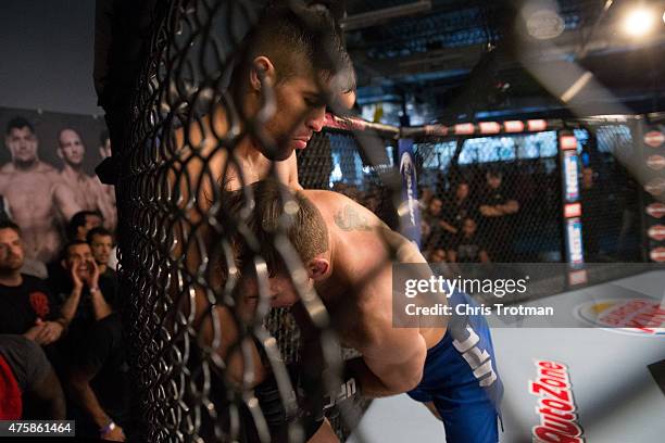 Nate Coy pushes Vicente Luque up against the cage during the filming of The Ultimate Fighter: American Top Team vs Blackzilians on February 17, 2015...