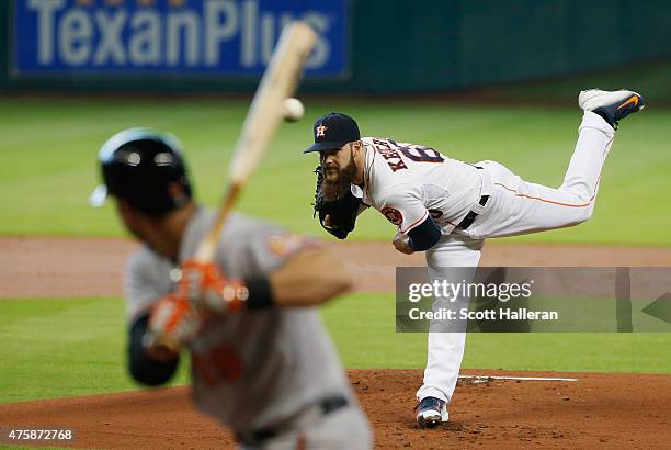 Dallas Keuchel of the Houston Astros throws a pitch in the first inning to Chris Davis of the Baltimore Orioles during their game at Minute Maid Park...