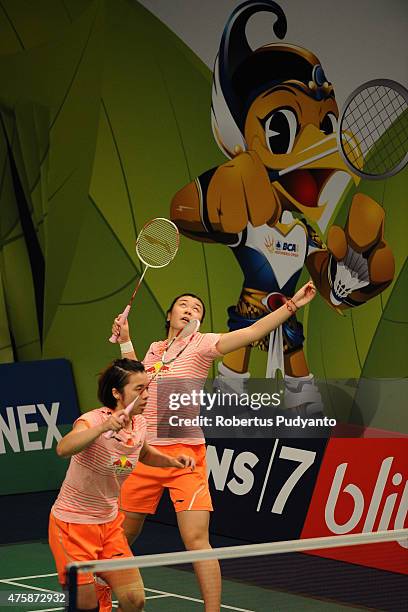 Tang Jinhua and Tian Qing of China return a shot against Naoko Fukuman and Kurumi Yonao of Japan during the 2015 BCA Indonesia Open Round 2 match on...