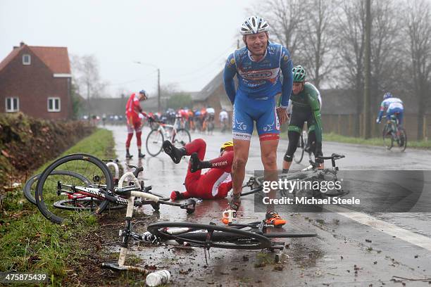 Laurens de Vreese of Wanty-Groupe Gobert Team grimaces in pain after a crash in wet conditions during the Omloop Het Nieuwsblad on March 1, 2014 in...