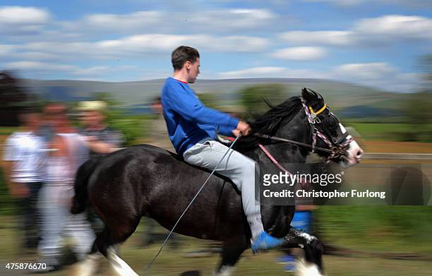 Travellers race their horses along the 'Mad Mile' during the Appleby Horse Fair on June 4, 2015 in Appleby, England. The Appleby Horse Fair has...