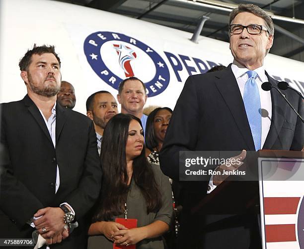 Former Texas Governor Rick Perry speaks as supporters including retired U.S. Navy SEAL and author of the book "Lone Survivor" Marcus Luttrell stand...