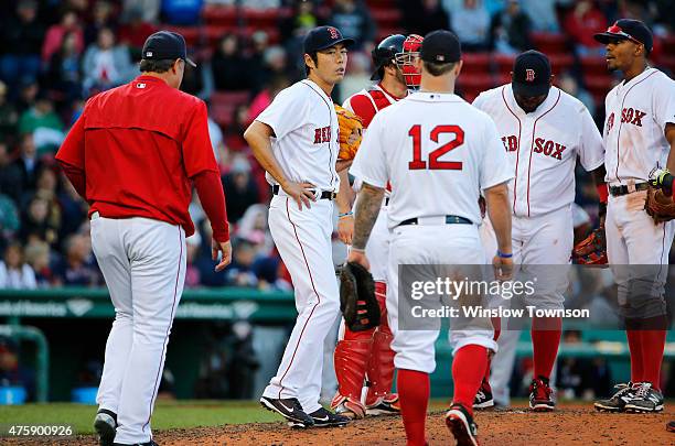 Pitcher Koji Uehara of the Boston Red Sox waits on the mound for a visit from Manager John Farrell of the Boston Red Sox during the ninth inning of...