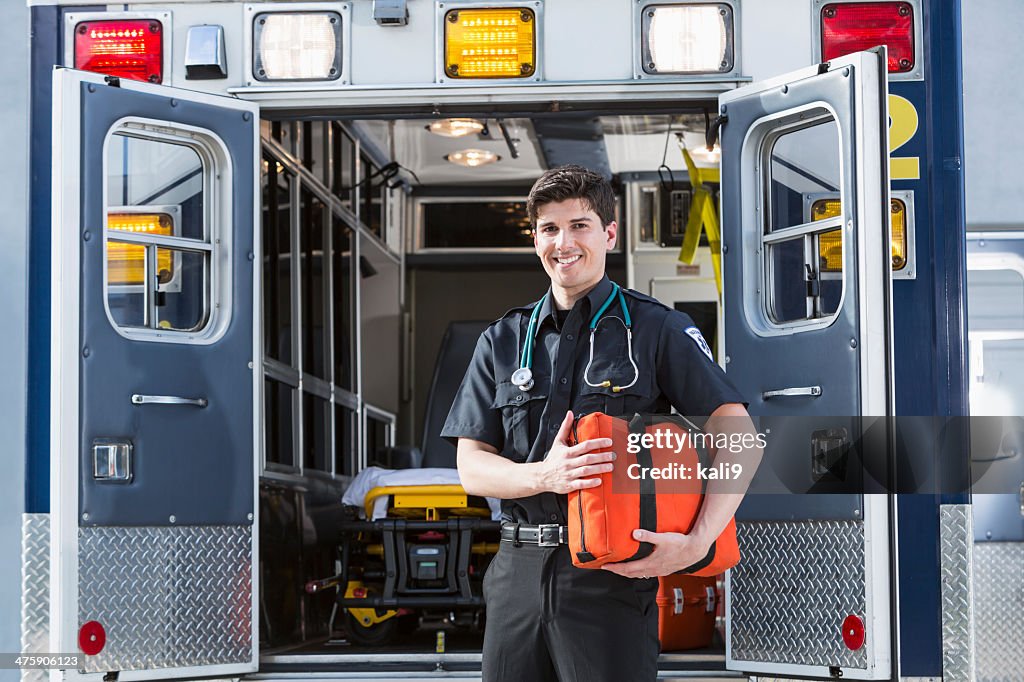 Paramedic standing by ambulance