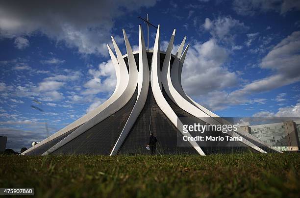 Man stands during the holiday of Corpus Christi outside the Cathedral of Brasilia on June 4, 2015 in Brasilia, Brazil. The tradition is celebrated on...