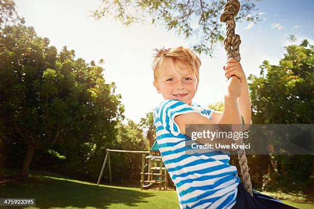 boy on zip line swing, smiling - tree canopy pattern fotografías e imágenes de stock