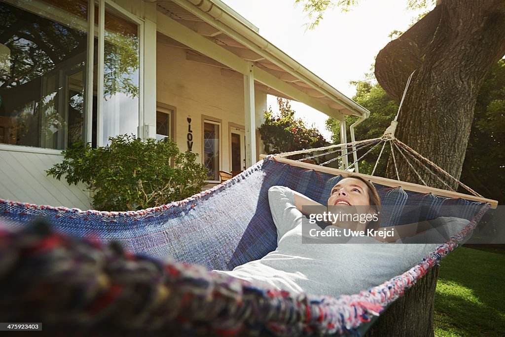 Woman relaxing in hammock, otudoors