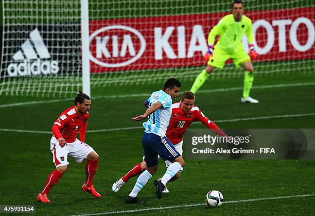 Angel Correa of Argentina is challenged by Markus Blutsch of Austria during the FIFA U-20 World Cup New Zealand 2015 Group B match between Austria...