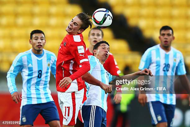 Andreas Gruber of Austria jumps for a header with Tomas Martinez of Argentina during the FIFA U-20 World Cup New Zealand 2015 Group B match between...