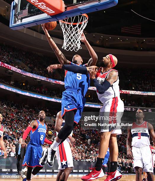 Arnett Moultrie of the Philadelphia 76ers shoots against Drew Gooden of the Washington Wizards during a game at Wells Fargo Center in Philadelphia,...