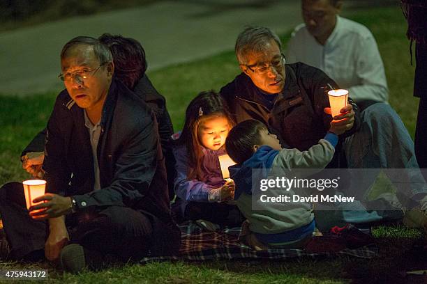 People participate in a candlelight vigil near the Los Angeles Chinese Consulate to commemorate the anniversary of the 1989 Tiananmen Square massacre...