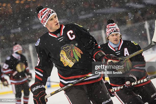 Jonathan Toews of the Chicago Blackhawks looks on as teammate Duncan Keith skates behind during the 2014 NHL Stadium Series against the Pittsburgh...