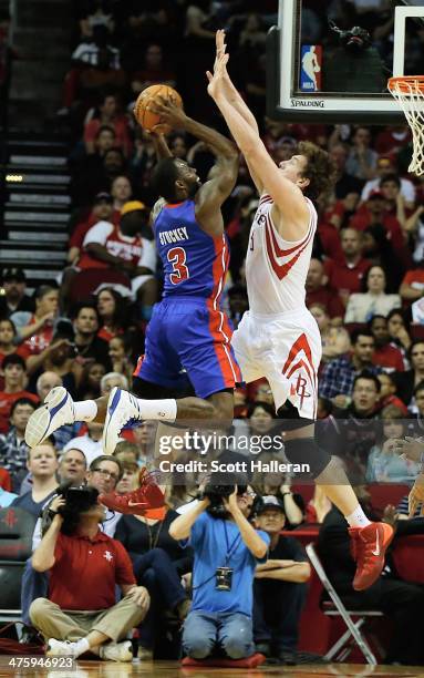 Rodney Stuckey of the Detroit Pistons shoots over Omer Asik of the Houston Rockets during the game at the Toyota Center on March 1, 2014 in Houston,...