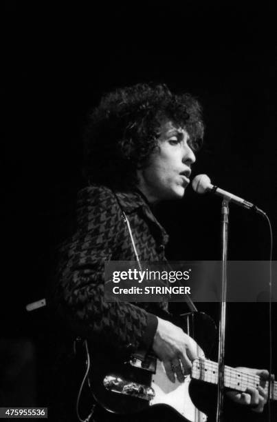 Photo taken on May 25, 1966 shows American rock and folk musician Bob Dylan singing and plaing guitar during a concert at the Olympia music hall in...