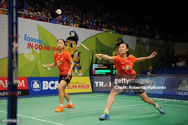 Ma Jin and Tang Yuanting of China returns a shot against Lee So Hee and Shin Seung Chan of Korea during the 2015 BCA Indonesia Open Quarterfinals...